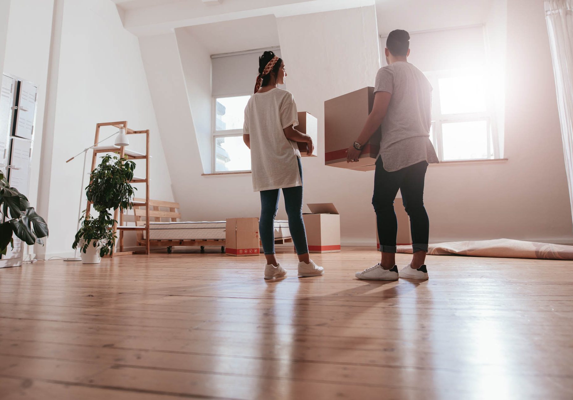 Young couple moving in new house moving home